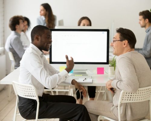 Define Your Target Audience-friendly-smiling-diverse-male-colleagues-having-pleasant-conversation-work VNV Events-The Ultimate Guide to Event Marketing: Promoting Your Event Effectively