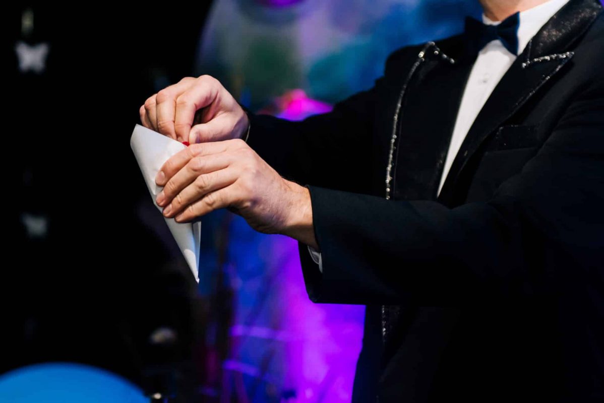The hand of the magician with the bag holds a magical ritual, trick Wedding day Entertainment
