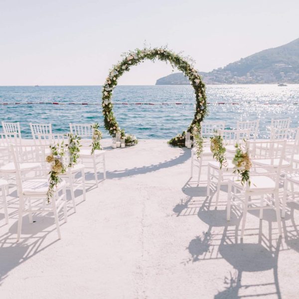 WEDDING ARCH RECEPTION WITH SEA VIEW in Montenegro. White wedding reception venue with sea and mountains view. Destination wedding venue.
