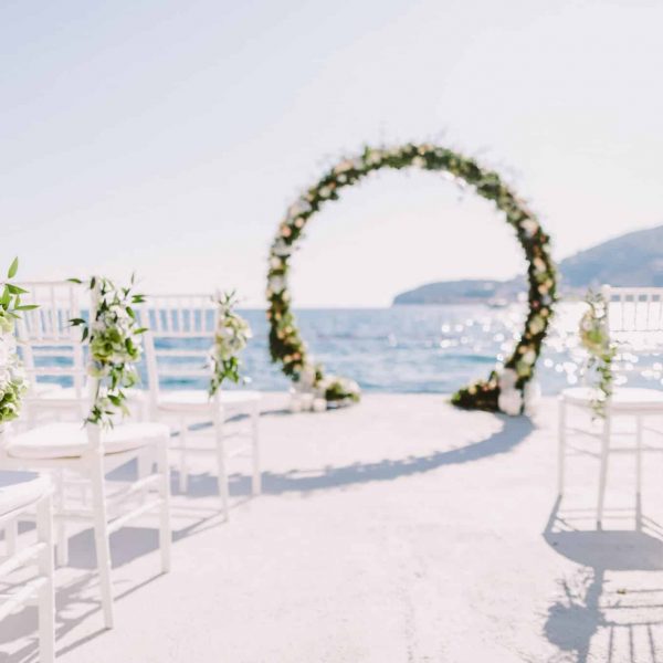WEDDING ARCH RECEPTION WITH SEA VIEW in Montenegro. White wedding reception venue with sea and mountains view. Destination wedding venue.